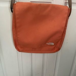 NORTHFACE  ORANGE CROSSBODY BAG has some wear